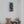 Load image into Gallery viewer, Colours of Home canvas print by Adam Young on a white wall above potted succulents and a woven basket
