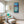 Load image into Gallery viewer, Daisies by Adam Young framed in a bright reading nook beside a floor lamp, armchair and ottoman
