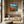 Load image into Gallery viewer, Patch of Poppies by Adam Young on a wood-panelled wall above a stone bench
