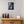 Load image into Gallery viewer, Black Fish Blue Moon framed paper print shown in a room setting
